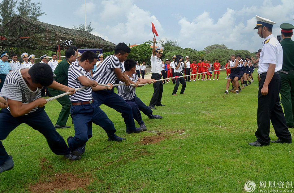 This handout photo taken on June 8, 2014 and released by the Philippine Navy on June 11 shows members of the Philippine (back R-in white) and Vietnamese (L-in stripes) navies taking part in a tug-of-war game during a day of friendly games and cultural exchanges on the contested islands in the Spratlys archipelago in the South China Sea. Filipino and Vietnamese troops played volleyball and football in the contested South China Sea archipelago on June 8, a landmark act of sports diplomacy that both sides said could ease territorial tensions. AFP PHOTO / Philippine Navy --- EDITORS NOTE -- RESTRICTED TO EDITORIAL USE - MANDATORY CREDIT "AFP PHOTO / PHILIPPINE VAVY" - NO MARKETING - NO ADVERTISING CAMPAIGNS - DISTRIBUTED AS A SERVICE TO CLIENTS