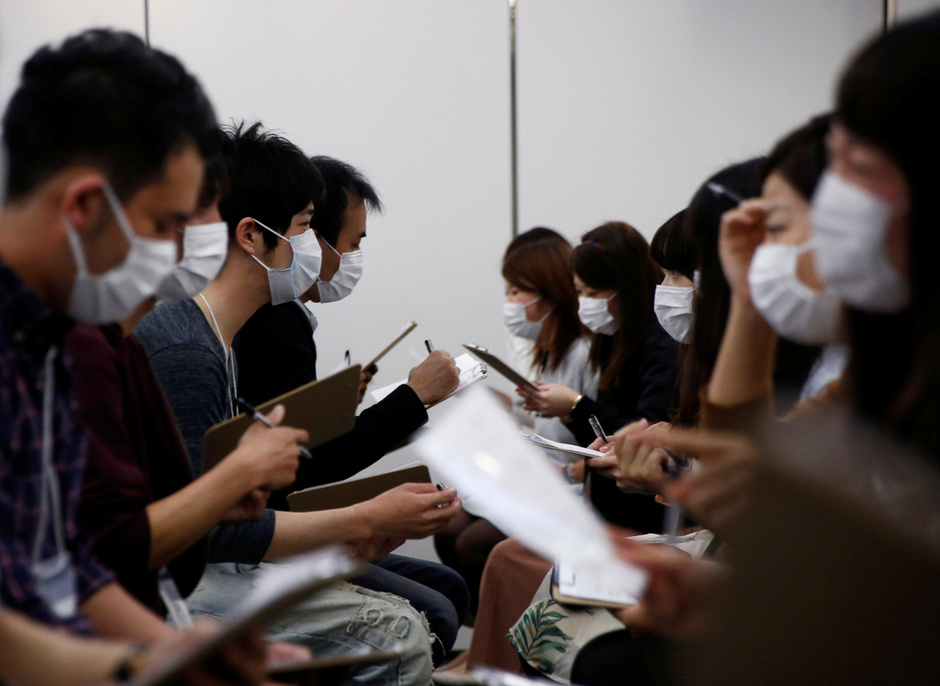Participants wearing surgical masks talk to each other during a masked match-making event in Tokyo, Japan, October 16, 2016. Picture taken on October 16, 2016.   REUTERS/Kim Kyung-Hoon