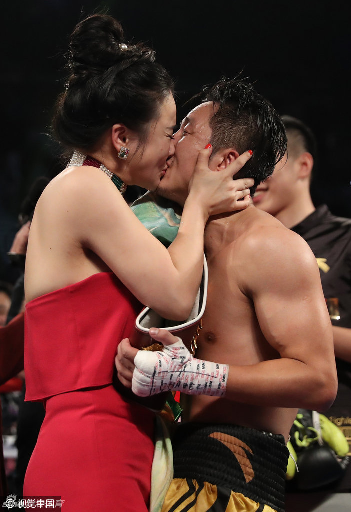 LAS VEGAS, NV - NOVEMBER 05: Zou Shiming of China celebrates with his wife, Yingying Ran, after his unanimous-decision victory over Prasitsak Phaprom of Thailand during their WBO flyweight championship fight at the Thomas & Mack Center on November 5, 2016 in Las Vegas, Nevada. Shiming won the WBO flyweight championship. (Photo by Christian Petersen/Getty Images)