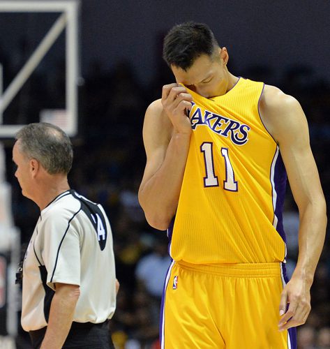 Oct 19, 2016; San Diego, CA, USA; Los Angeles Lakers forward Yi Jianlian (11) wipes sweat away during the fourth quarter against the Golden State Warriors at Valley View Casino Center. Mandatory Credit: Jake Roth-USA TODAY Sports